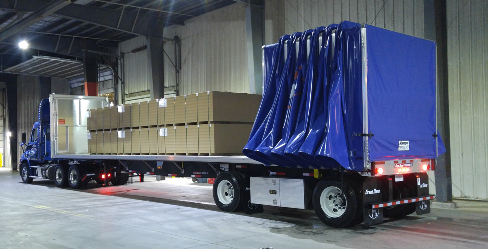 Conestoga roll-tarp trailer protecting sensitive freight